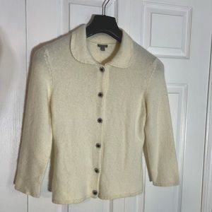 Cream angora sweater with black rhinestone buttons. Size medium.